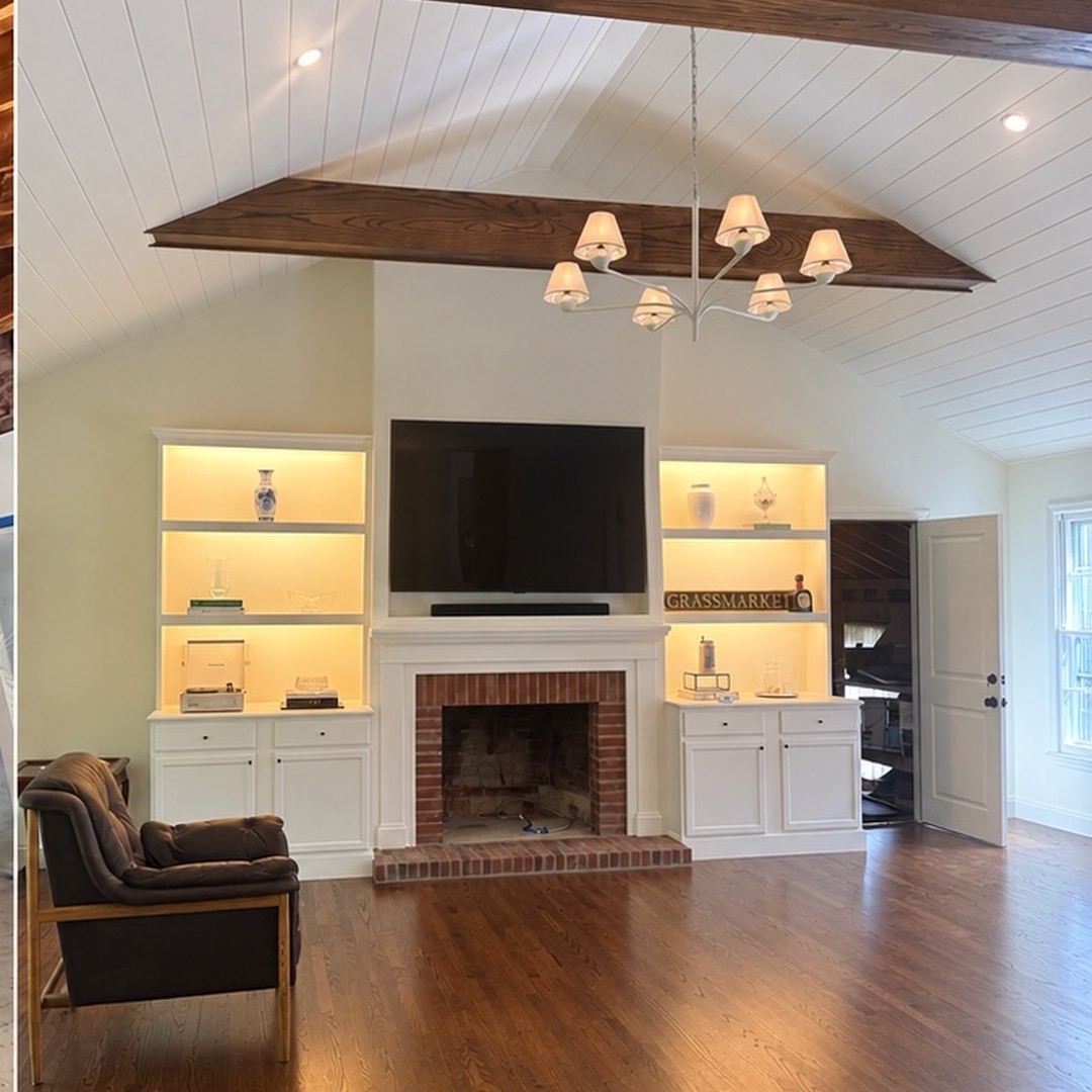 Finished vaulted living room renovation with wood beams and built-in shelving